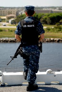 US Navy 100503-N-3154P-030 Aviation Boatswain's Mate Airman Junelle Santonia stands watch on the flight deck of the multipurpose amphibious assault ship USS Wasp (LHD 1)