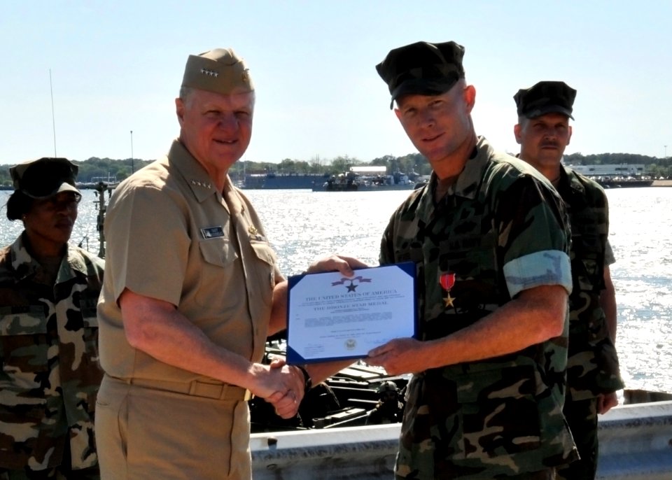US Navy 100429-N-4267W-205 Chief of Naval Operations (CNO) Adm. Gary Roughead presents Cmdr. Bruce Nevel with the Bronze Star Medal