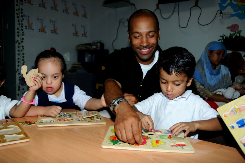 US Navy 100429-N-6832D-064 Gunner's Mate 1st Class Juan Rutledge and Sailors assigned to the amphibious transport dock ship USS Mesa Verde (LPD 19) spend the day tutoring and enjoying recreational playtime at the Regional Insti