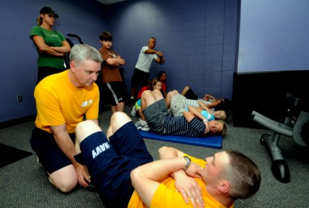 US Navy 100504-N-5208T-010 Crew member demonstrate the proper Navy sit-up during a SEAL Fitness Challenge at the Birmingham YMCA photo