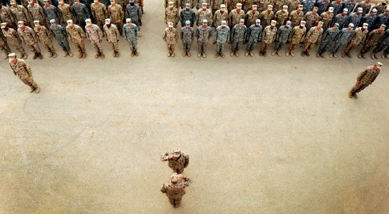 US Navy 100430-N-7130B-031 Service members assigned to Special Operations Task Force West stand in formation during a memorial marking the anniversary of the death of Explosive Ordnance Disposal Technician 2nd Class Tyler Traha