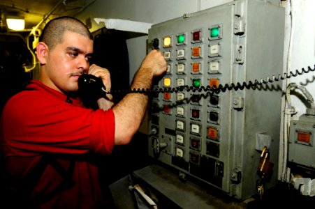 US Navy 100504-N-6604E-039 A Sailor aboard USS Dwight D. Eisenhower (CVN 69) uses a sound-powered phone to communicate with personnel several decks below