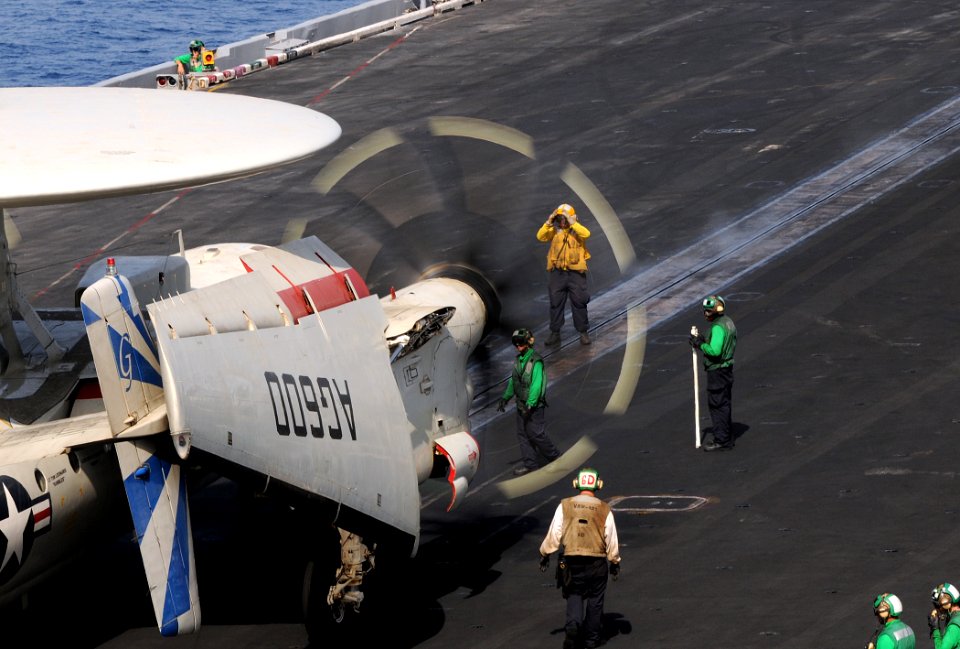 US Navy 100502-N-4236E-090 A Sailor directs an E-2C Hawkeye assigned to the Bluetails of Airborne Early Warning Squadron (VAW) 121 to the catapult aboard the aircraft carrier USS Dwight D. Eisenhower (CVN 69)