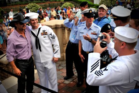 US Navy 100505-N-8590G-001 Country music singer Tim McGraw poses with a Sailor before performing a five-song musical tribute dedicated to the nation's military photo