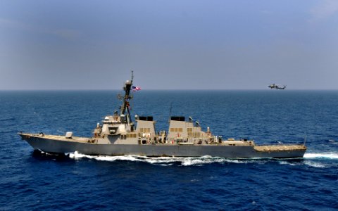 US Navy 100503-N-3595W-010 An SH-60 Sea Hawk helicopter assigned to The Nightdippers of Helicopter Anti-Submarine Squadron (HS) 5 hovers over the guided-missile destroyer USS McFaul (DDG 74)