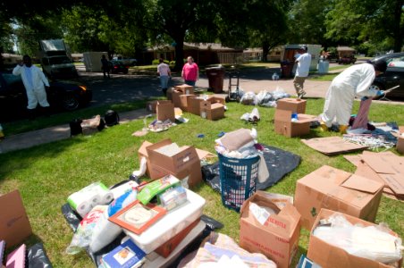 US Navy 100506-N-5319A-015 Volunteers help Ship's Serviceman 1st Class Scott Overstreet and his wife remove their belongings after severe flooding damaged many of their personal items in a family housing area of Naval Support A
