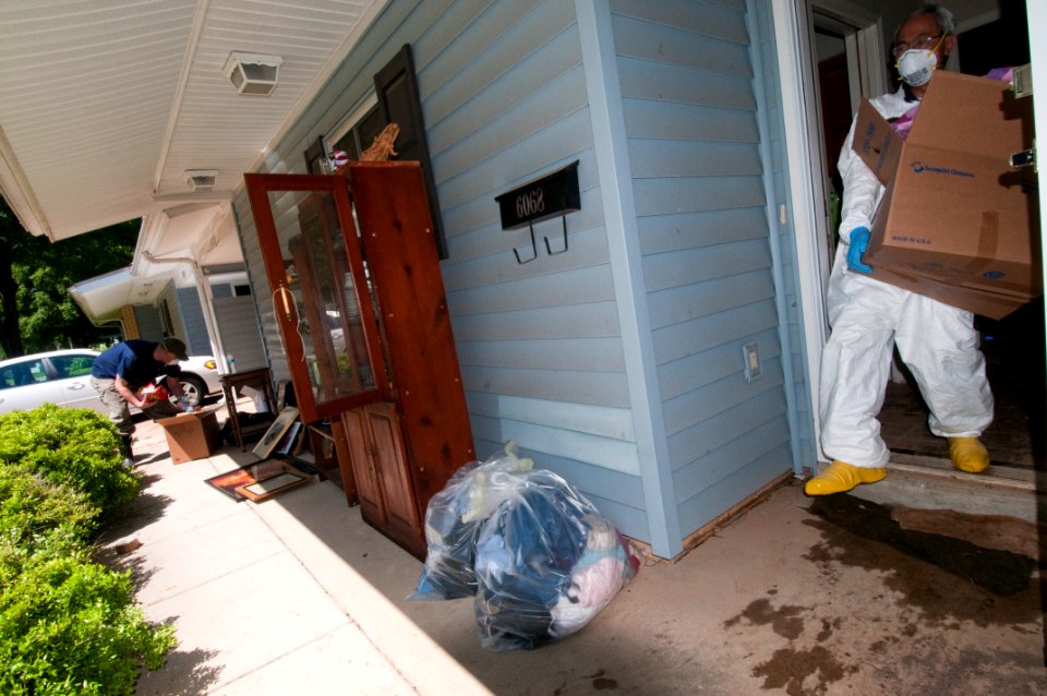 US Navy 100506-N-5319A-014 Volunteers help Ship's Serviceman 1st Class Scott Overstreet and his wife remove their belongings after severe flooding damaged many of their personal items in a family housing area of Naval Support A