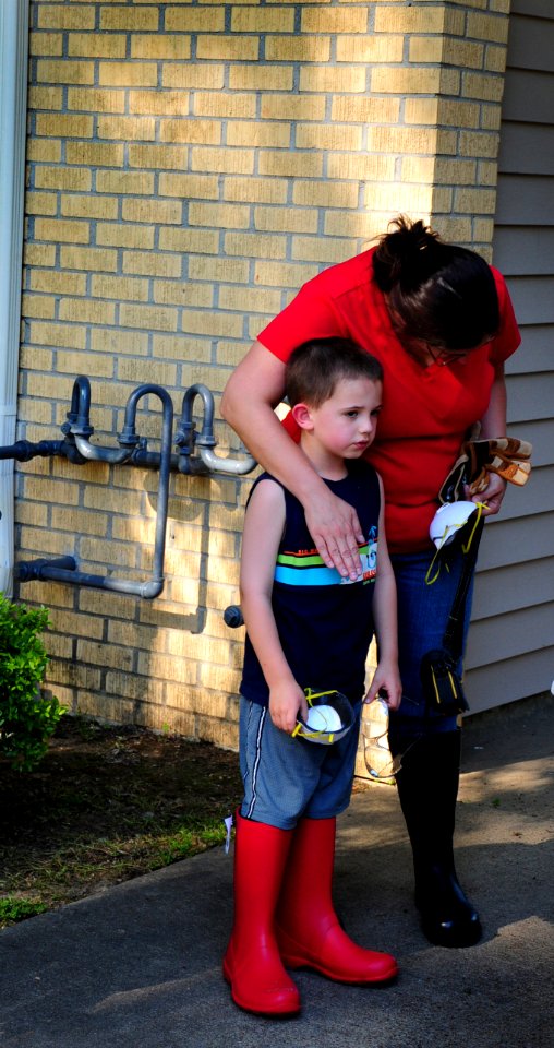US Navy 100504-N-6046S-052 A flood victim comforts her son as they recover personal items from their flooded home at Naval Support Activity Mid-South
