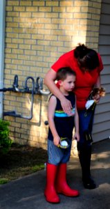 US Navy 100504-N-6046S-052 A flood victim comforts her son as they recover personal items from their flooded home at Naval Support Activity Mid-South