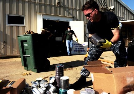 US Navy 100506-N-5862D-004 Chief Mass Communication Specialist George Kusner disposes of spools of CDs and DVDs that were damaged by floodwaters at the Navy Recruiting Command storage annex photo