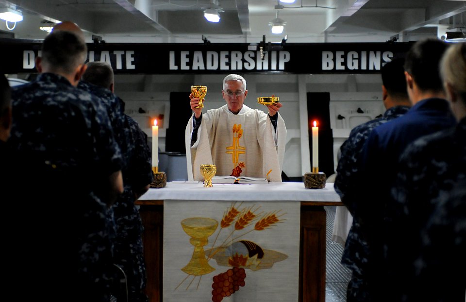 US Navy 100502-N-7605J-047 Lt. William Dorwart leads a congregation during Roman Catholic religious mass