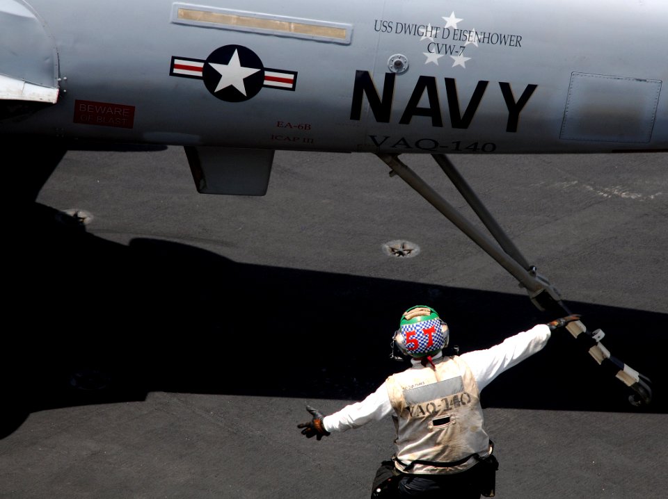 US Navy 100504-N-4236E-042 A Sailor gives directions to raise the tailhook of an EA-6B Prowler assigned to the Patriots of Electronic Attack Squadron (VAQ) 140 aboard the aircraft carrier USS Dwight D. Eisenhower (CVN 69)