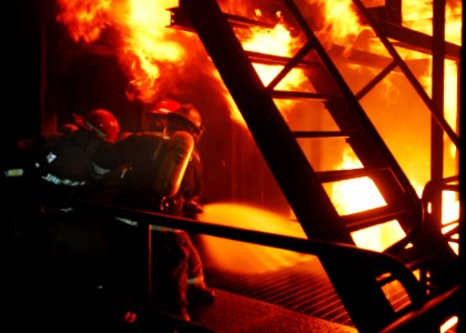US Navy 100505-N-2218S-003 A hose team applies water to a fire during firefighting training at the Yokosuka Center for Naval Engineering Fire Fighting and Damage Control Learning Site