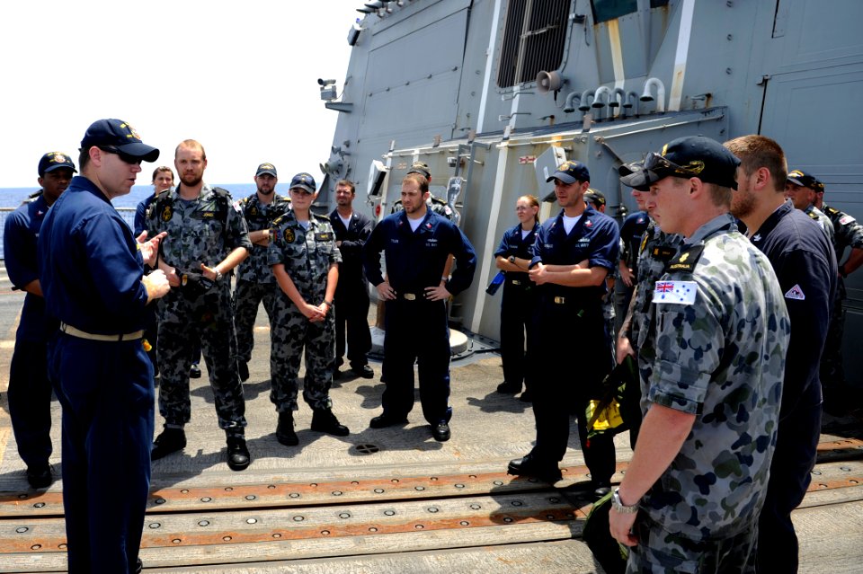 US Navy 100506-N-8959T-103 Lt. Timothy Shanley, operations officer aboard the Arleigh Burke-class guided-missile destroyer USS Farragut (DDG 99), welcomes aboard a group of Australian navy Sailors