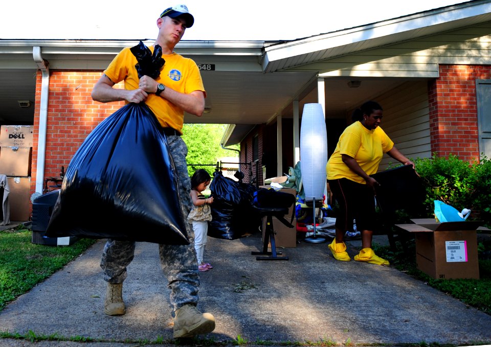 US Navy 100505-N-5862D-017 Chief Petty Officer Jason Reynolds helps his neighbors pack their household goods into a storage trailer at Naval Support Activity Mid-South in Millington, Tenn