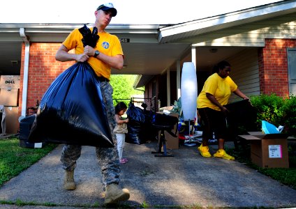 US Navy 100505-N-5862D-017 Chief Petty Officer Jason Reynolds helps his neighbors pack their household goods into a storage trailer at Naval Support Activity Mid-South in Millington, Tenn