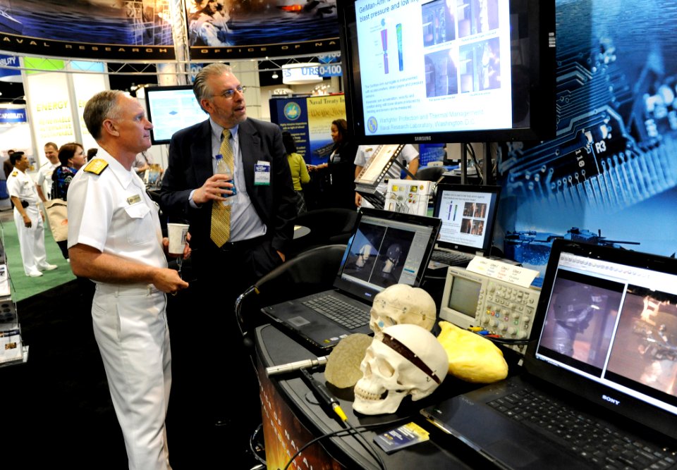 US Navy 100504-N-7676W-014 Dr. Peter Matic, head of the multifunctional materials branch at the Naval Research Laboratory, explains his work to Rear Adm. Nevin Carr, Chief of Naval Research,