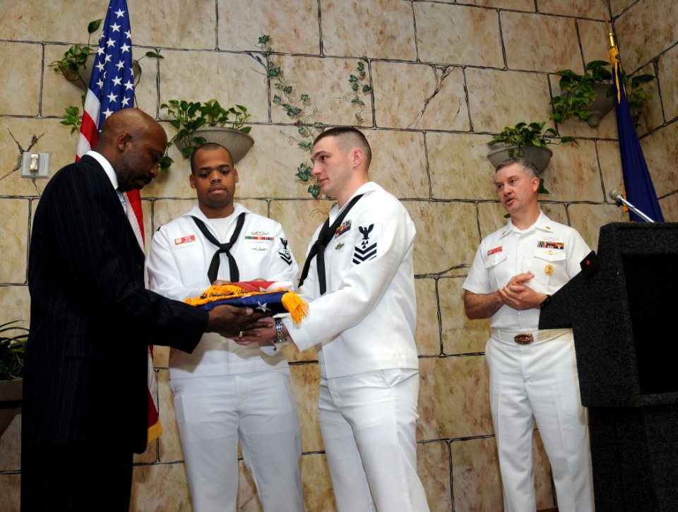 US Navy 100504-N-5208T-005 Sailors assigned to the ballistic-missile submarine USS Alabama (SSBN 731) present an Alabama state flag that was flown over the submarine