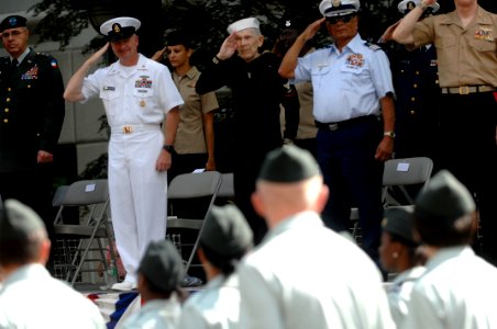 US Navy 100507-N-9818V-118 Master Chief Petty Officer of the Navy (MCPON) Rick West and Con Crabb salute Junior ROTC students from the reviewing stand during the 61st Armed Forces Day Parade