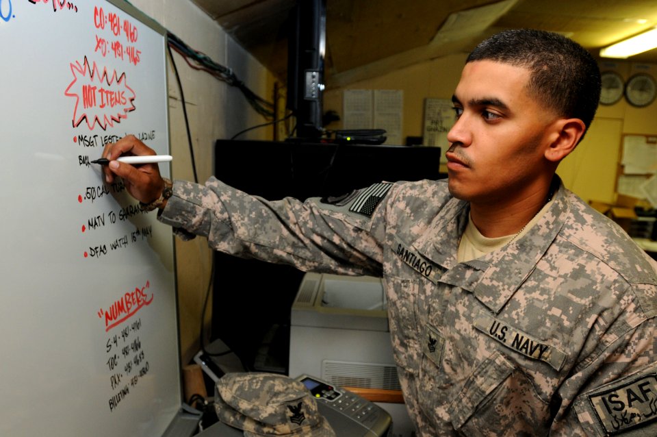 US Navy 100508-F-6228L-060 Petty Officer 1st Class Wilson Santiago, from Irvington, N.J. assigned to the Paktika Provincial Reconstruction Team, is in his workspace at Bagram Air Field