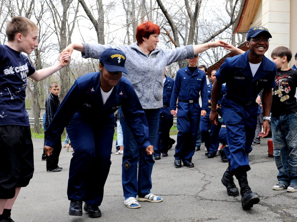 US Navy 100508-N-1675O-390 Intelligence Specialist 3rd Class Lauren Jones and Culinary Specialist Seaman Myron Gordon, both assigned to the U.S. 7th Fleet command ship USS Blue Ridge (LCC 19), are bid farewell by the children