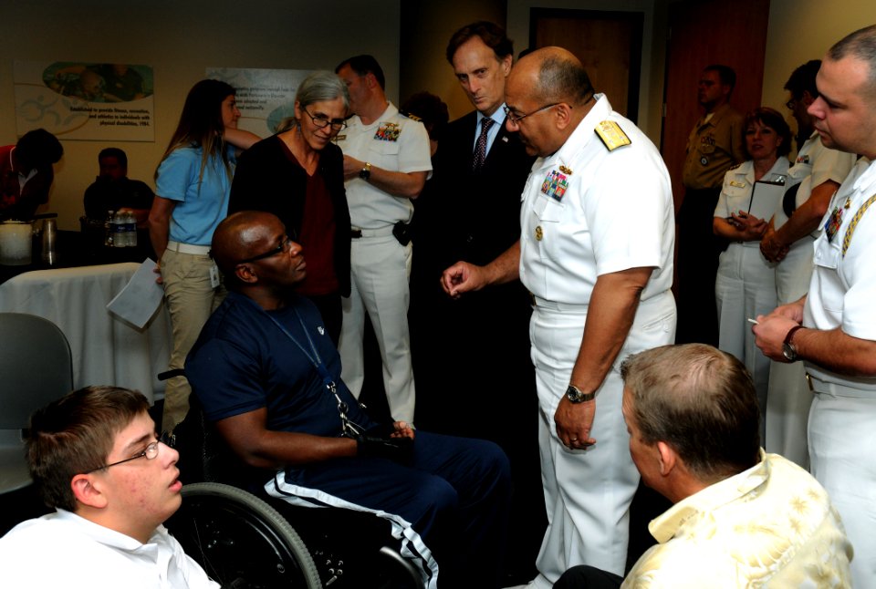 US Navy 100505-N-5208T-004 Vice Adm. Adam M. Robinson Jr. speaks with a wounded warrior at the Lakeshore Foundation in Birmingham, Ala