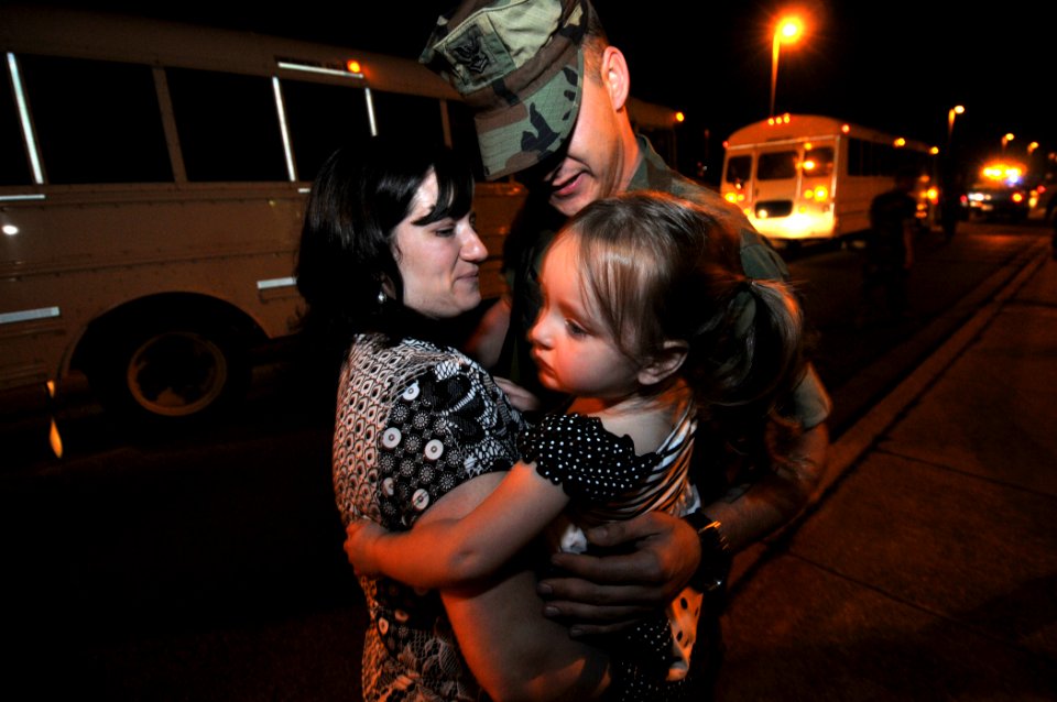 US Navy 100505-N-7367K-001 Steelworker 2nd Class Jean-Luc Pelchats the first to greet his family during his battalion's homecoming at Naval Construction Battalion Center, Gulfport