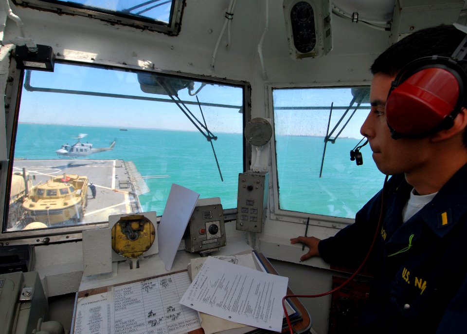 US Navy 100505-N-6138K-019 Ensign John Thomson directs an Spanish navy AB-212 helicopter