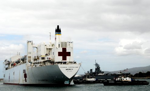 US Navy 100508-N-7498L-024 Tugboats help maneuver the Military Sealift Command hospital ship USNS Mercy (T-AH 19) into Joint Base Pearl Harbor-Hickam photo