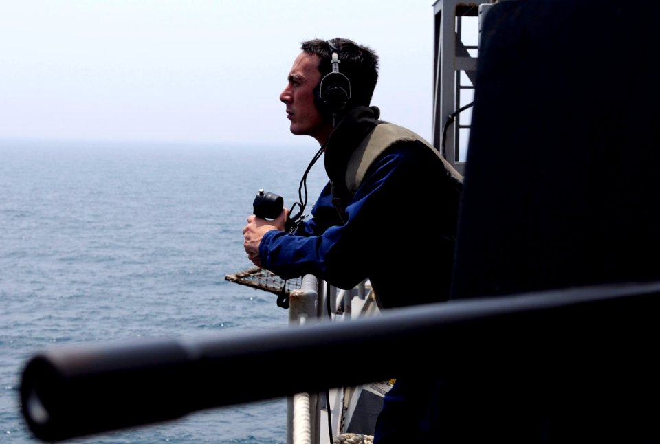 US Navy 100505-N-7478G-125 Information Systems Technician 2nd Class Michael Ervin mans a sound-powered phone during a small-caliber action team drill