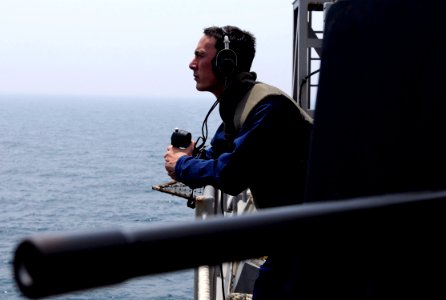 US Navy 100505-N-7478G-125 Information Systems Technician 2nd Class Michael Ervin mans a sound-powered phone during a small-caliber action team drill