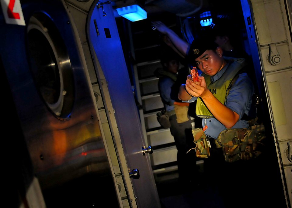 US Navy 100506-N-7643B-169 A sailor from the Royal Brunei Navy posts watch on a passage way during a visit, board, search, and seizure exercise aboard the U.S. Coast Guard cutter Mellon (WHEC 717)