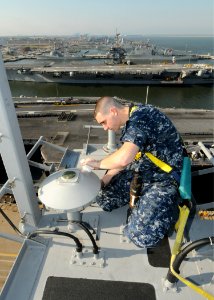 US Navy 100506-N-6509M-007 Electronics Technician 3rd Class Cory J. Boswell performs maintenance on a global positioning system