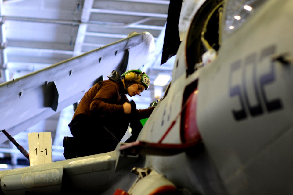 US Navy 100509-N-6604E-071 Aviation Machinist's Mate Airman Recruit Samuel Sorenson removes dirt and debris from vital systems in an E-A-6B Prowler assigned to Electronic Attack Squadron (VAQ) 131 aboard the aircraft carrier US