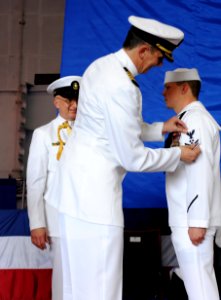 US Navy 100506-N-5082P-104 Capt. Ron Horton frocks Machinist's Mate 3rd Class Zachary J. Gaines to 2nd class petty officer during a change of command ceremony aboard USS Enterprise (CVN 65)