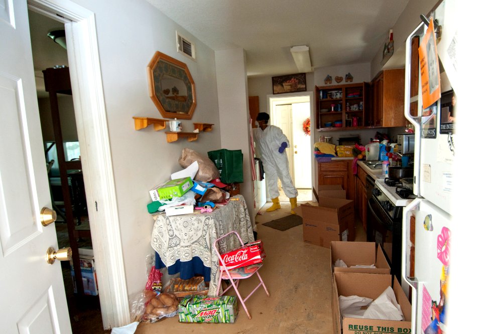 US Navy 100506-N-5319A-013 Volunteers help Ship's Serviceman 1st Class Scott Overstreet and his wife remove their belongings after sever flooding destroyed many of their personal items at Naval Support Activity Mid-South