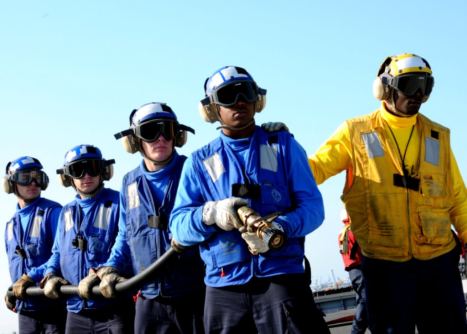 US Navy 100506-N-9793B-016 Air department Sailors man an aqueous film forming foam hose aboard the aircraft carrier USS George H.W. Bush (CVN 77)