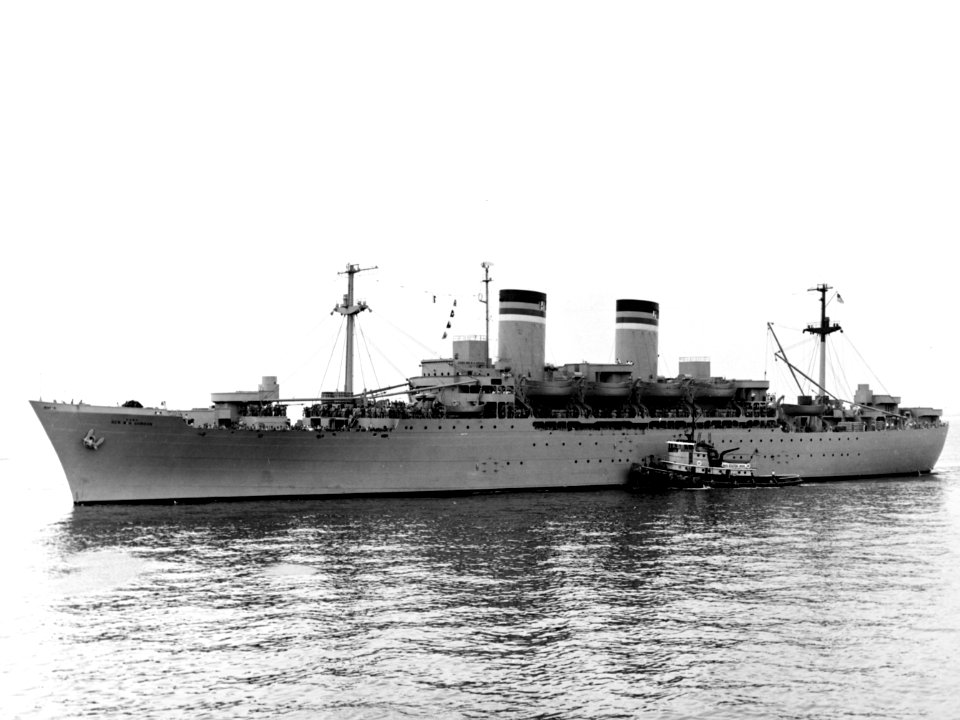 USNS General W. H. Gordon (T-AP-117) with a tug, circa in the 1950s (NH 104839)