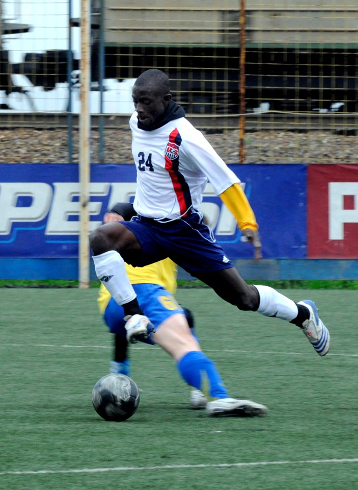 US Navy 100510-N-7478G-409 Personnel Specialist 3rd Class Ernest Baah jumps to avoid a Russian player trying to steal the soccer ball