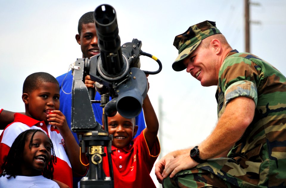 US Navy 100508-N-7367K-004 Children visit a static display of an M-134D Gatling Gun during Seabee Day at Naval Construction Battalion Center, Gulfport