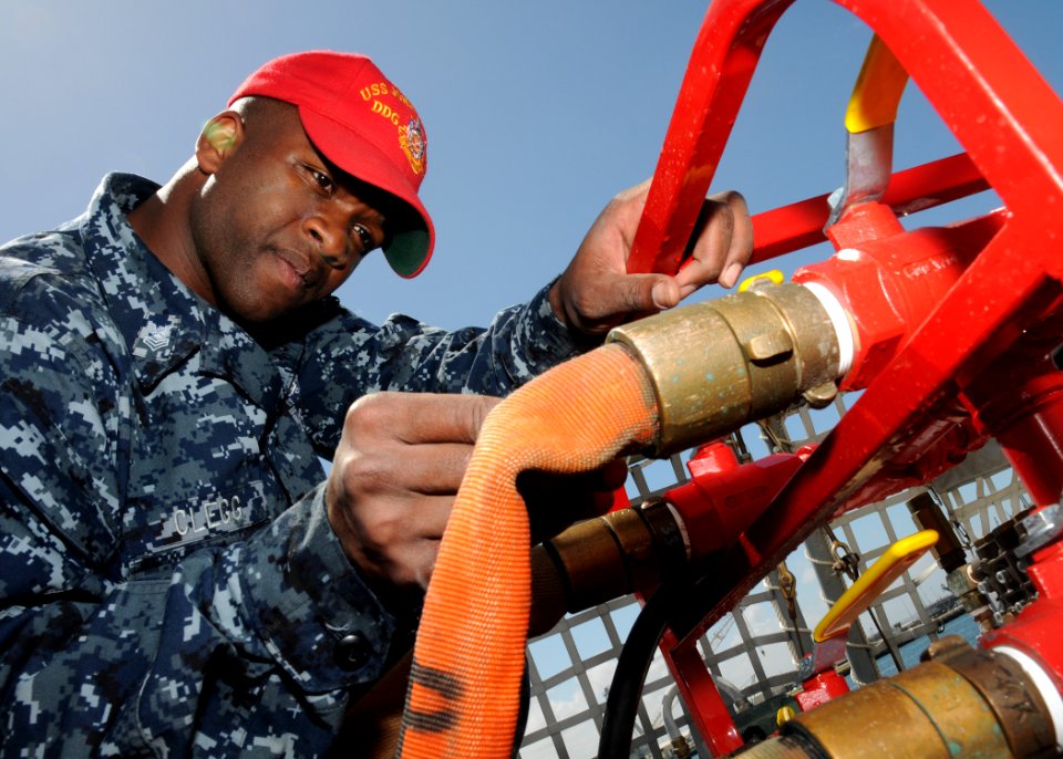 US Navy 100511-N-2259P-019 Damage Controlman 1st Class Brian Clegg inspects a fire hose aboard USS John Paul Jones (DDG 53)