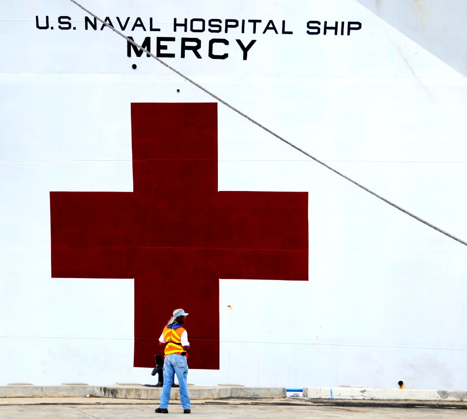 US Navy 100508-N-7498L-278 A civilian contractor assigned to Fleet and Industrial Supply Center Pearl Harbor waits for the Military Sealift Command hospital ship USNS Mercy (T-AH 19) to line up along the pier before manning the