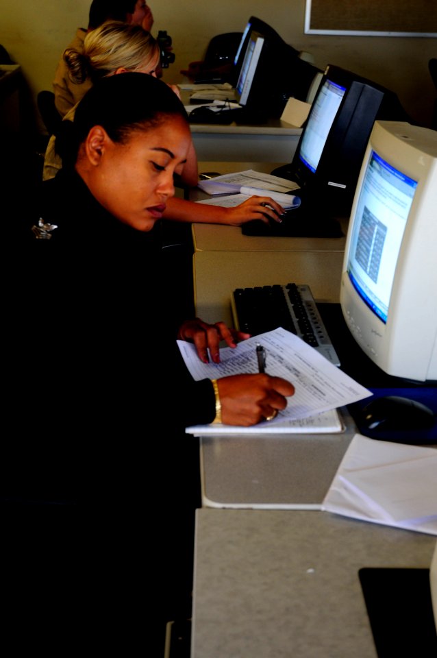 US Navy 100511-N-4995K-045 Yeoman 1st Class Primivita Brown-Oenneke takes notes during a computer-based revised Yeoman and Personnel Specialists Advanced Administration Course at the Center for Service Support learning site