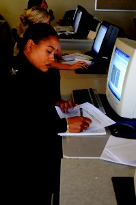 US Navy 100511-N-4995K-045 Yeoman 1st Class Primivita Brown-Oenneke takes notes during a computer-based revised Yeoman and Personnel Specialists Advanced Administration Course at the Center for Service Support learning site
