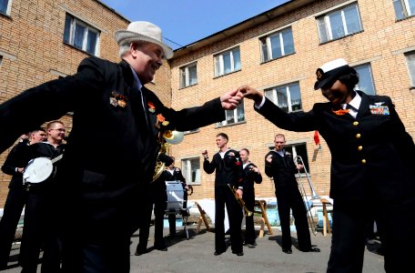 US Navy 100509-N-5716H-499 Chief Yeoman Roszetta Dean dances with a Russian veteran to music of the U.S. 7th Fleet Band