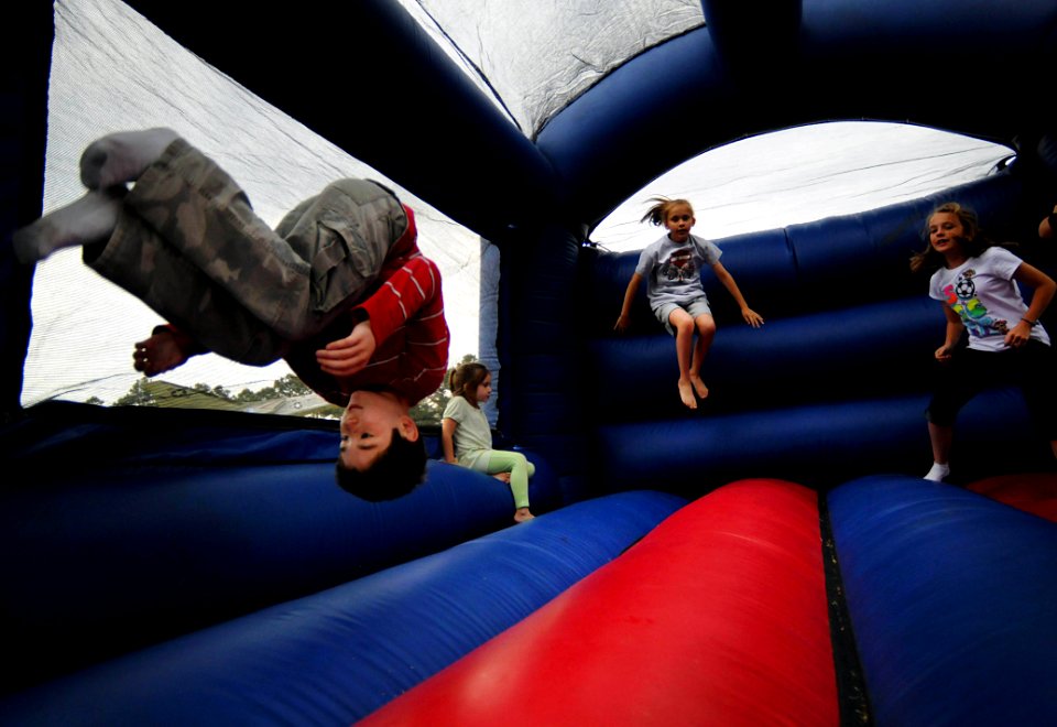 US Navy 100511-N-6046S-084 Children play on a moon bounce during the monthly We Care Supper