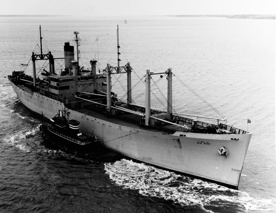 USNS Blue Jacket (T-AF-51) being maneuvered by tugs after being aground at Cheatham Annex, Virginia (USA), 9 March 1965 (USN 1111477-D)