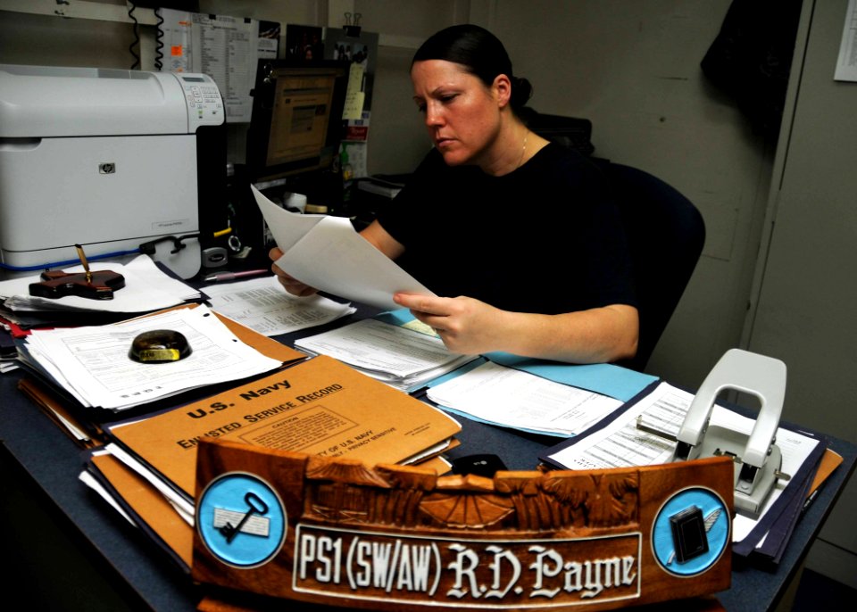 US Navy 100511-N-8936G-005 Personnel Specialist 1st Class Rhonda Payne, from Waco, Texas, reviews personnel records in the administration division office aboard the amphibious assault ship USS Nassau (LHA 4)