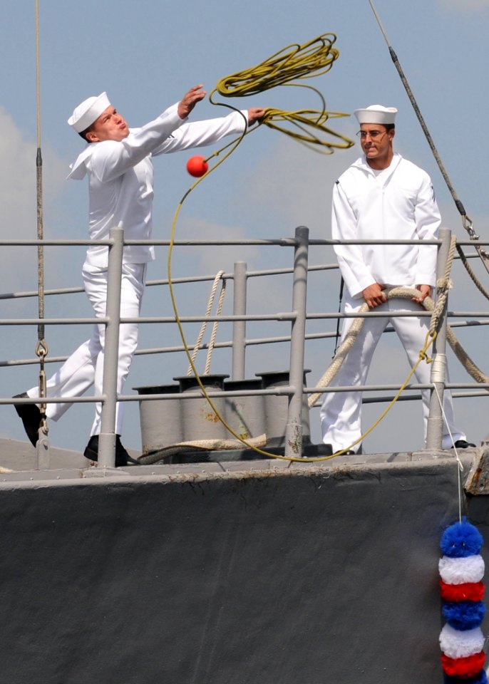 US Navy 100512-N-5538K-086 Mineman Seaman William Price throws a line to the pier from the mine countermeasures ship USS Patriot (MCM 7)