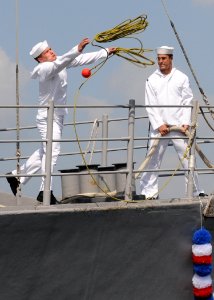US Navy 100512-N-5538K-086 Mineman Seaman William Price throws a line to the pier from the mine countermeasures ship USS Patriot (MCM 7)